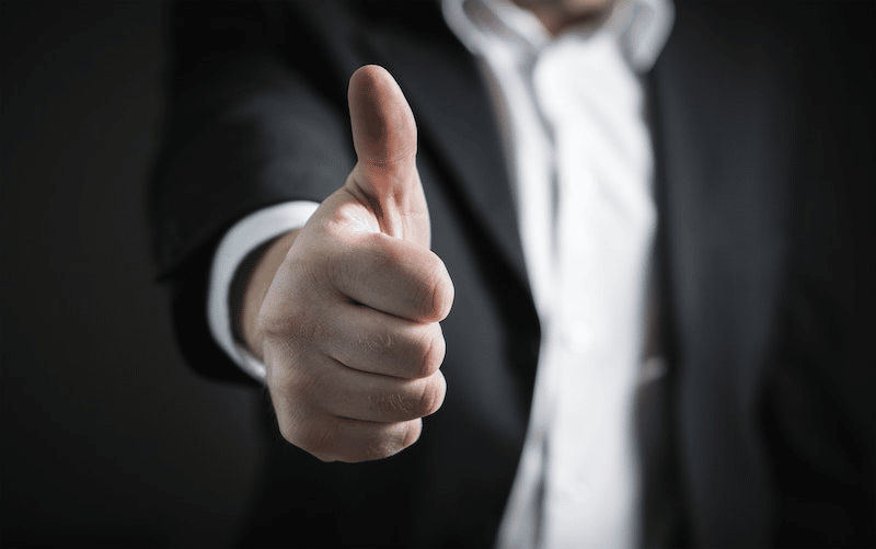 Best Alexandria SEO Company| WP Wizards 14 A man in a suit giving a thumbs up