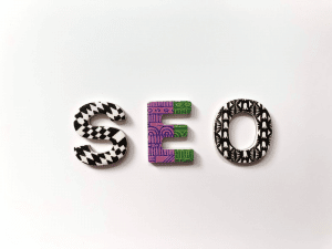 Master Your SEO with LinkWhisper | A Powerful Internal Linking Tool 8 The Word " SEO " written with multicoloured tiles