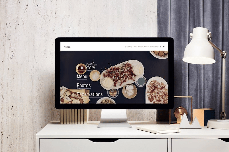 Squarespace Vs. WordPress: Which Is Better? 20 A workstation with a beautifully designed website on a monitor