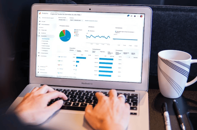 Who Is An SEO Consultant? 2 An SEO consultant using their laptop to check SEO metrics