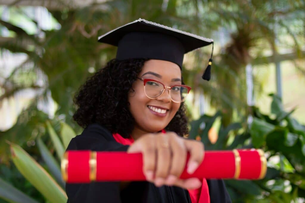 Udemy vs Coursera | The Ultimate Showdown Of These Popular Online Learning Platforms 18 smiling woman wearing academic dress and black academic hat