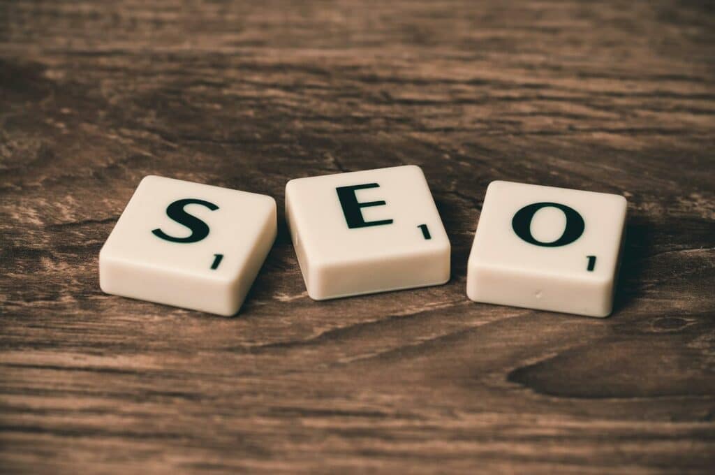 Unlocking SEO Website Success for Small Businesses: A Comprehensive Guide 16 Three White-and-black Scrabble Tiles on Brown Wooden Surface