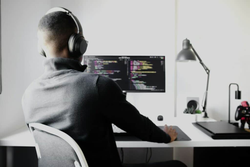 How A Full Stack Developer Can Transform Small Business Tech Strategies 13 man in black long sleeve shirt wearing black headphones sitting on chair