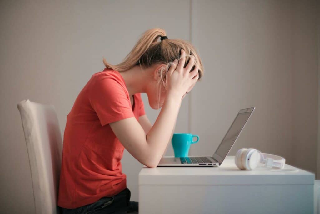 Suicide Awareness Month 2024: Prioritizing Mental Health in the Workplace 14 Woman in Red T-shirt Looking at Her Laptop