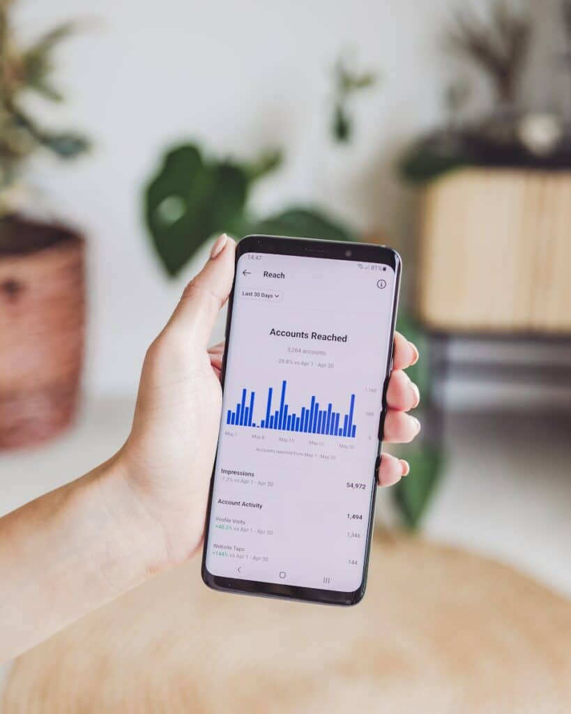 Designing for the Thumbs Up! Mastering Mobile Website Design for Small Businesses 15 a person holding a cell phone in their hand