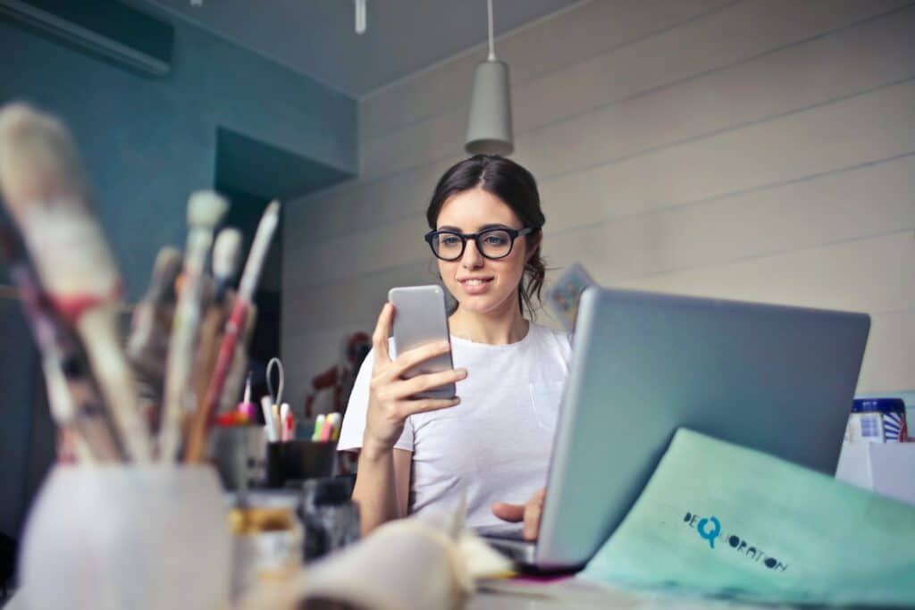 Designing for the Thumbs Up! Mastering Mobile Website Design for Small Businesses 11 woman in white shirt using smartphone