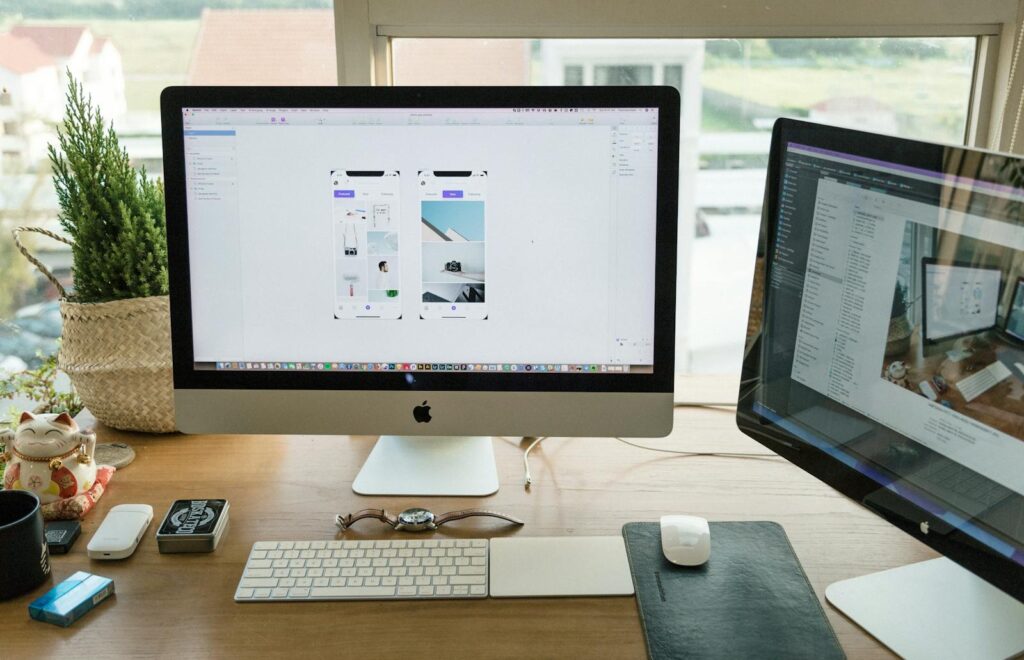 10 Inspiring Personal Website Ideas to Elevate Your Online Presence 15 A well-organized modern office setup featuring Apple iMac and multiple monitors in a bright workspace.