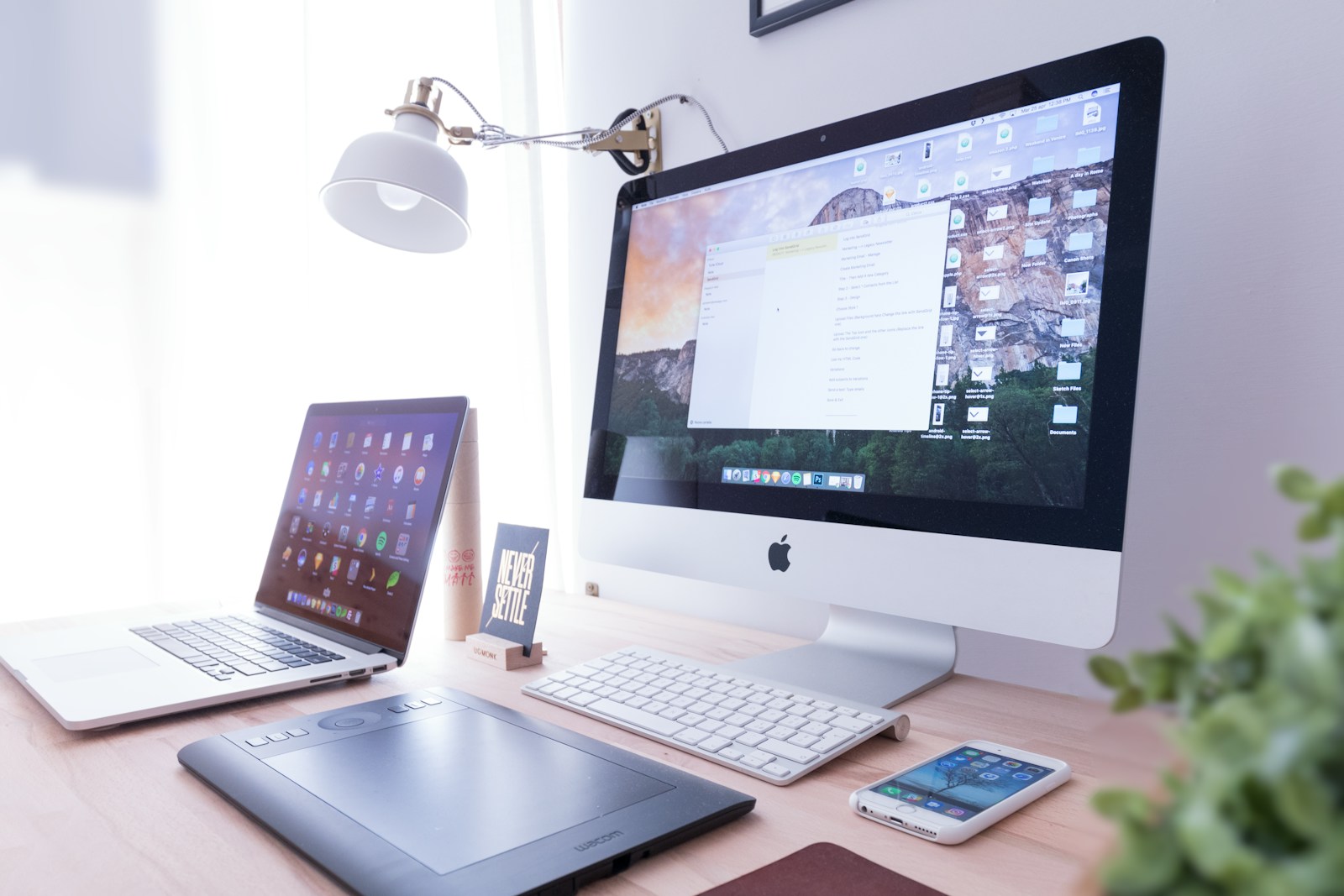 silver iMac near iPhone on brown wooden table custom web development services