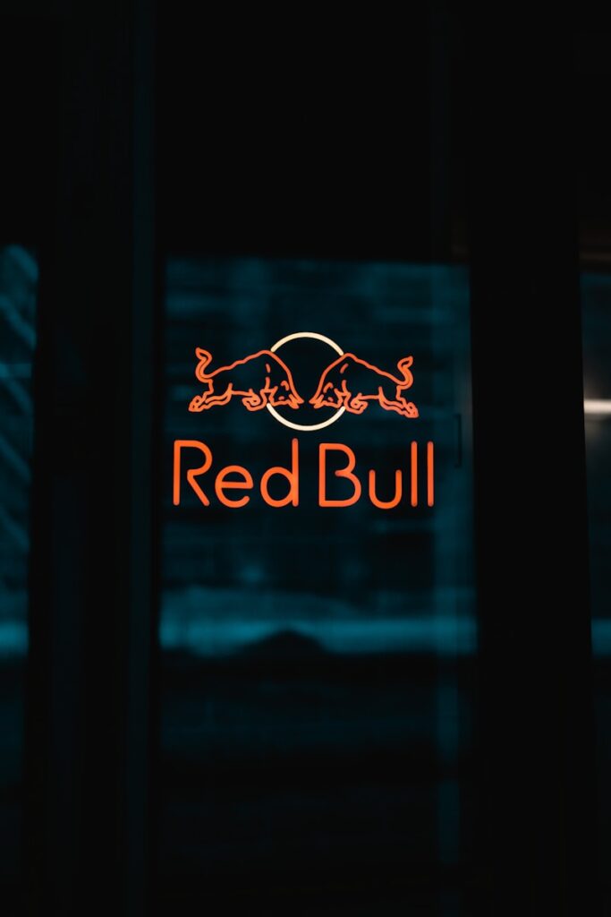 a red bull sign is lit up in the dark