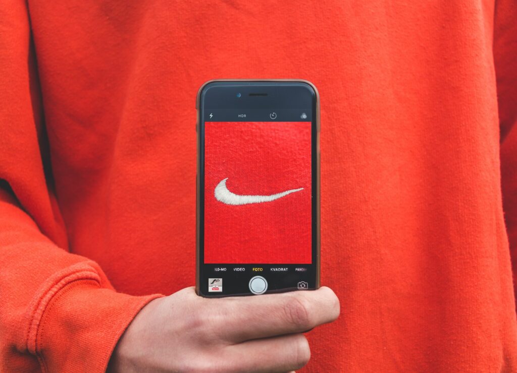 Top Brand Positioning Strategies to Elevate Your Business Approach 10 person holding iPhone taking picture on Nike label