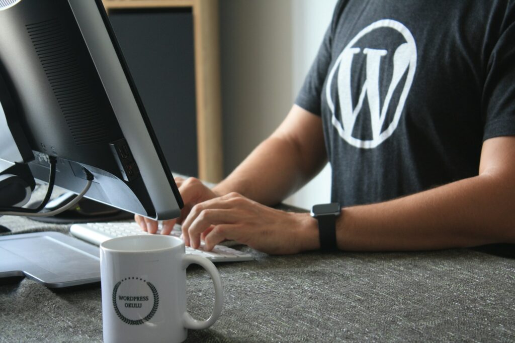 Boost Your Website’s Visibility with Expert WordPress SEO Services 13 person in black and white t-shirt using computer