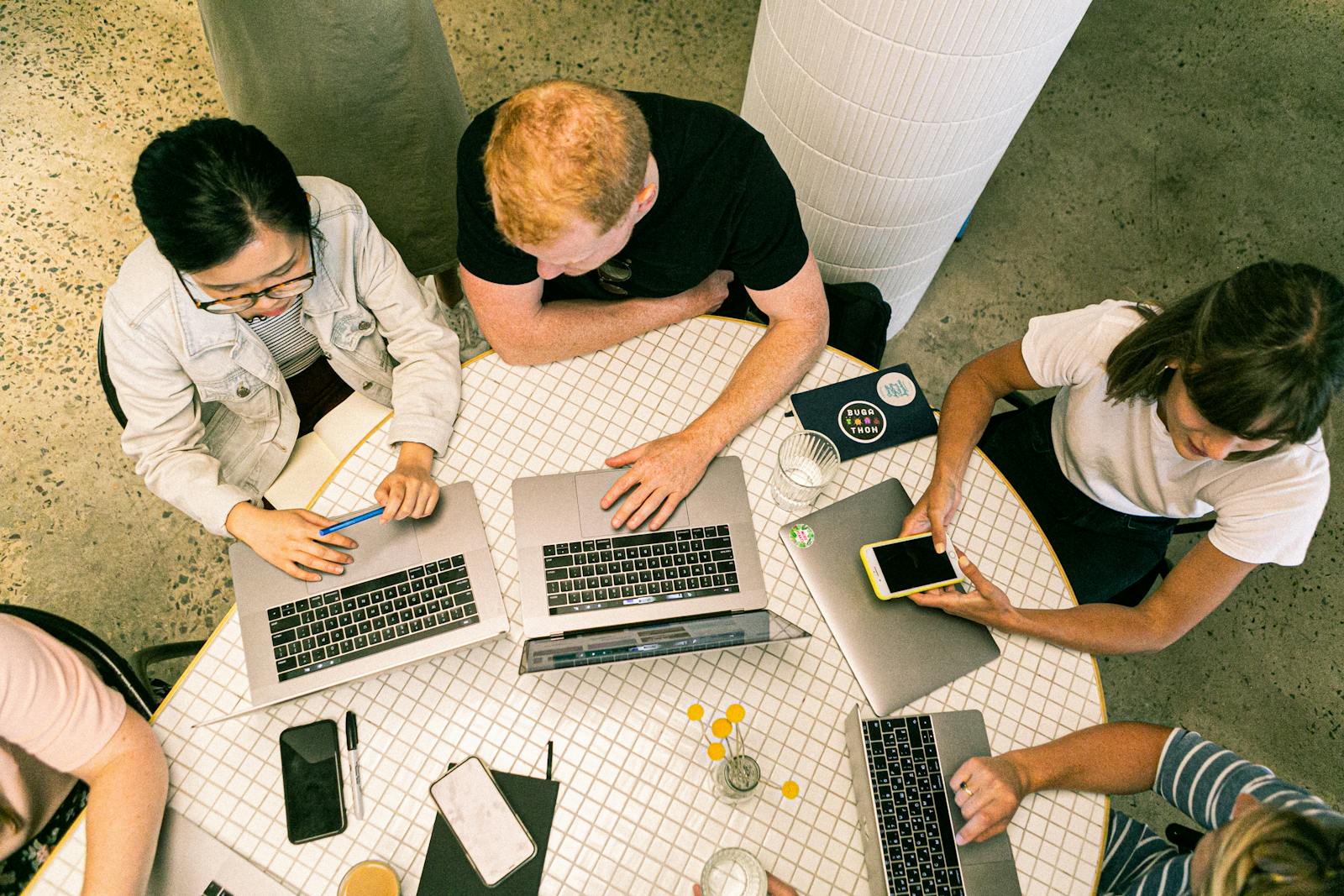 Photo by Canva Studio Top view of diverse team collaboratively working in a modern office setting. small business marketing agency