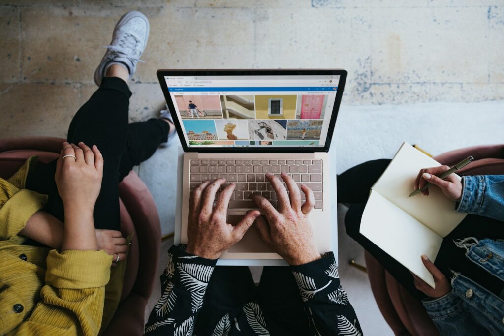 Choosing the Right Small Business Marketing Agency for Your Growth 15 person using microsoft surface laptop on lap with two other people