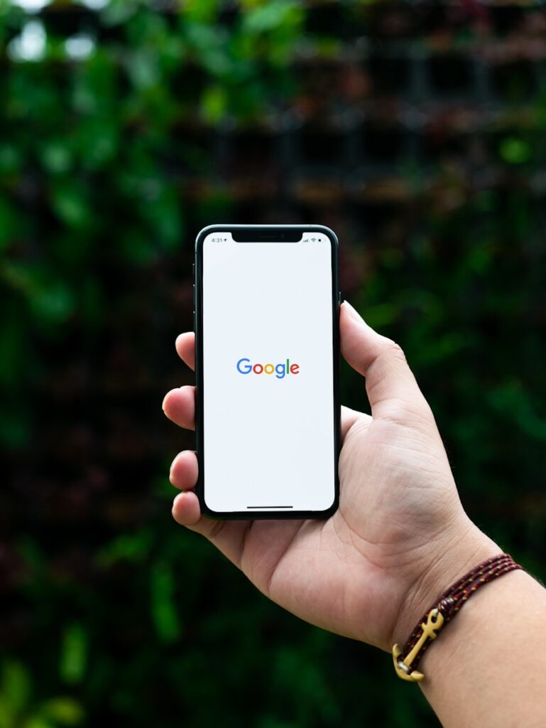 Partnering with a Google Ads Company for Small Business Growth | Priceless Consulting Should Be Your Top Choice For Google Campaign Management 14 person holding black android smartphone