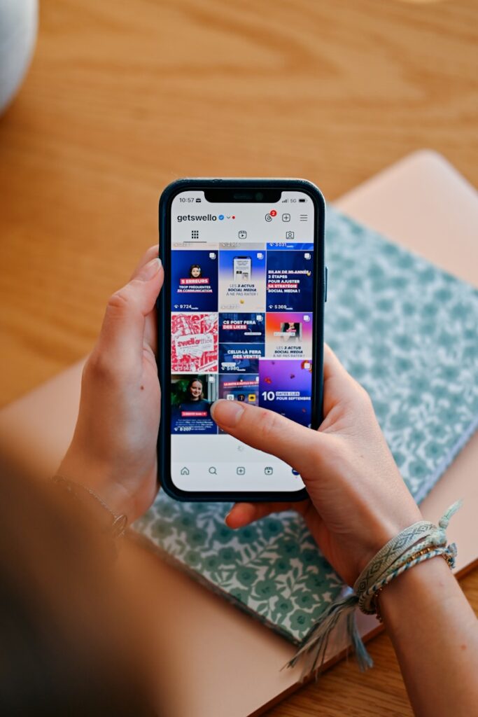 Hands holding phone displaying social media feed