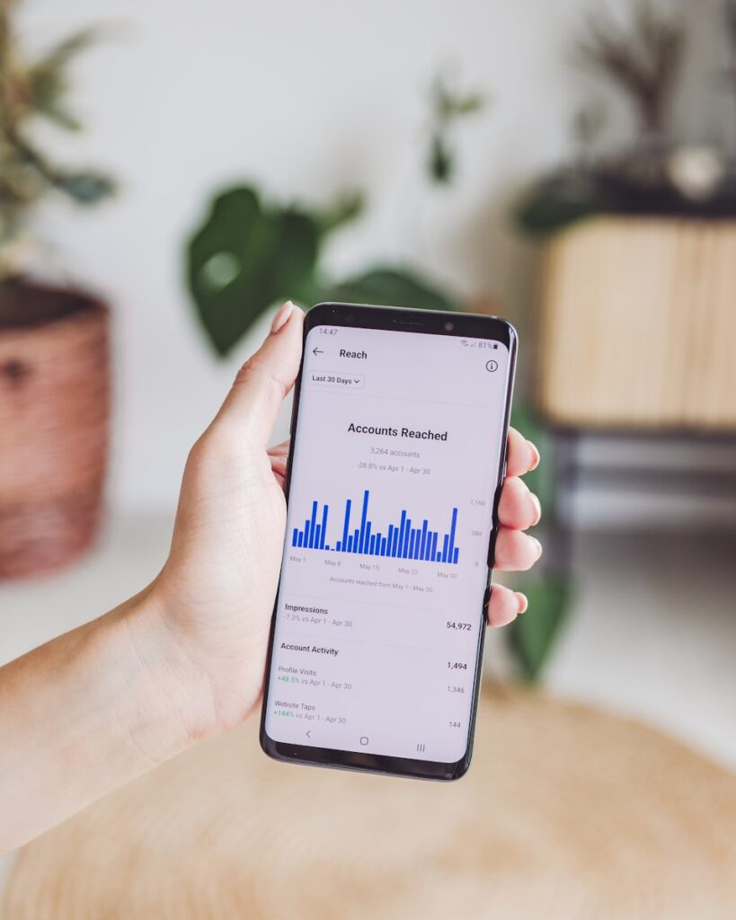Social Media Checks | Audits to Keep Your Strategy On Track 1 a person holding a cell phone in their hand