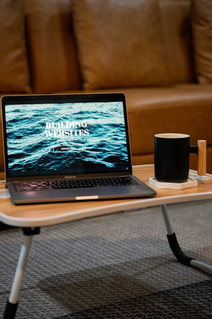 a laptop computer sitting on top of a wooden table